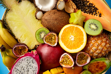 Image showing different exotic fruits on blue background