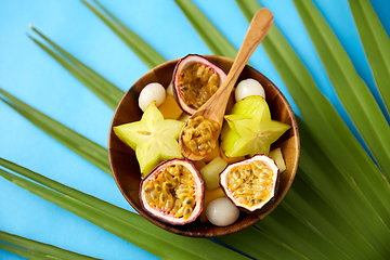 Image showing mix of exotic fruits in wooden plate with spoon