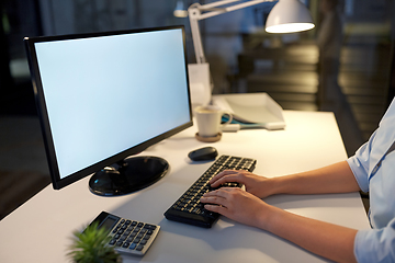 Image showing businesswoman working on computer at night office