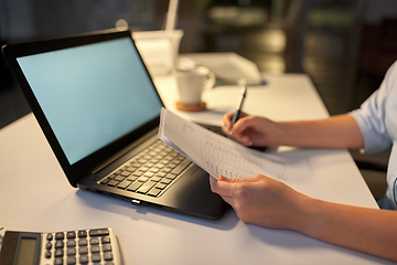 Image showing businesswoman with papers working at night office