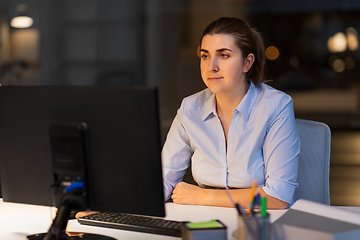 Image showing businesswoman working on computer at night office