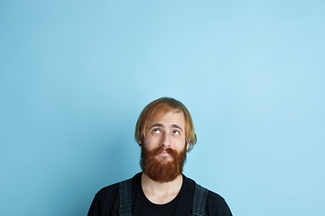 Image showing Portrait of young caucasian man looks dreamful and happy