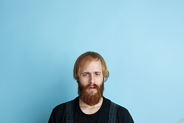 Image showing Portrait of young caucasian man looks dreamful and happy