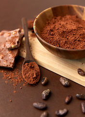 Image showing chocolate with hazelnuts, cocoa beans and powder