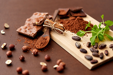 Image showing chocolate with nuts, cocoa beans and cinnamon