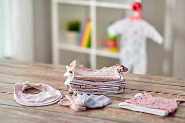 Image showing baby clothes on wooden table at home