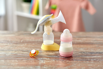 Image showing bottle with baby milk formula and breast pump