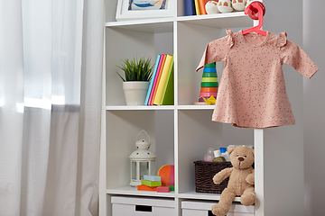 Image showing kid's room interior with bookcase and dress