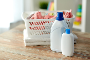 Image showing baby clothes in laundry basket with detergent