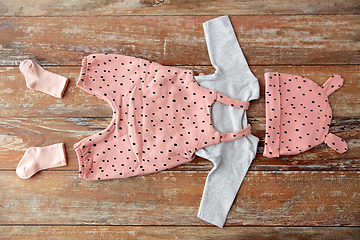 Image showing baby clothes set on wooden table