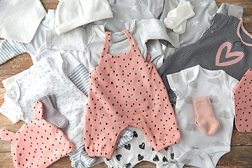 Image showing baby clothes set on wooden table