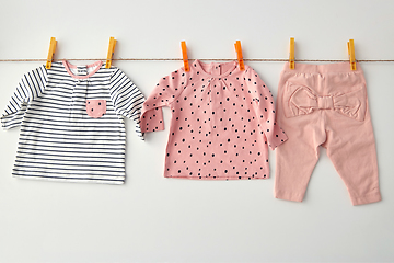 Image showing shirts and pants for baby girl on clothesline