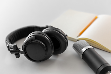 Image showing headphones, microphone and notebook with pencil