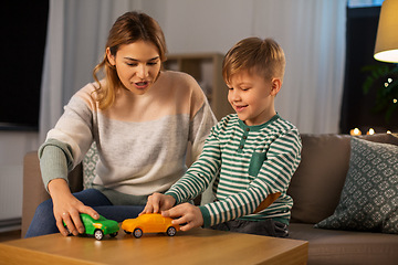 Image showing mother and son playing with toy cars at home