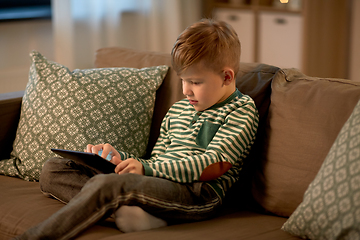 Image showing happy little boy with tablet computer at home