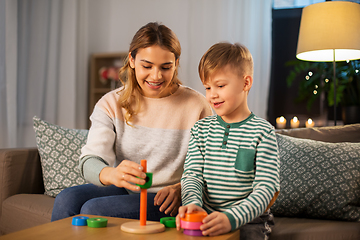 Image showing mother and son playing with toy pyramid at home