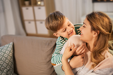 Image showing happy smiling mother and son hugging at home