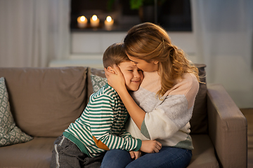 Image showing happy smiling mother and son hugging at home