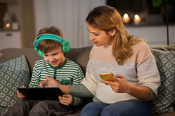 Image showing mother and son using gadgets at home