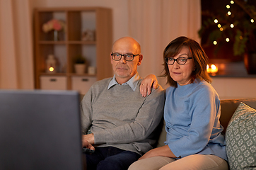 Image showing senior couple watching tv at home in evening