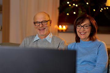 Image showing happy senior couple watching tv at home