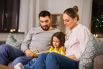 Image showing happy family reading book at home at night