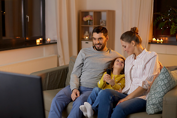 Image showing happy family watching tv at home at night