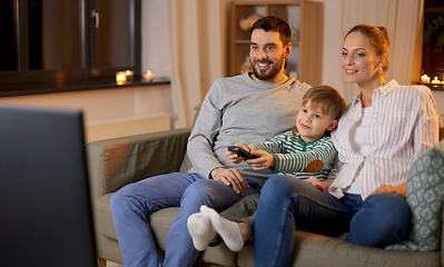 Image showing happy family watching tv at home at night