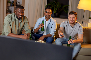 Image showing happy male friends with beer watching tv at home