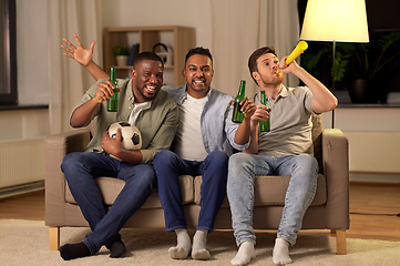 Image showing friends or soccer fans with ball and beer at home