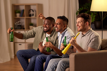 Image showing friends or soccer fans with ball and beer at home