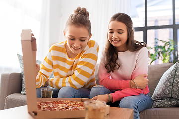 Image showing happy teenage girls eating takeaway pizza at home