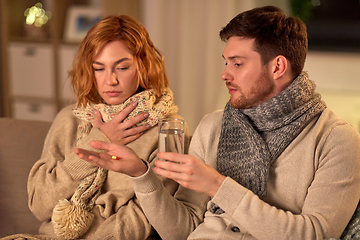 Image showing sick couple taking medicine at home