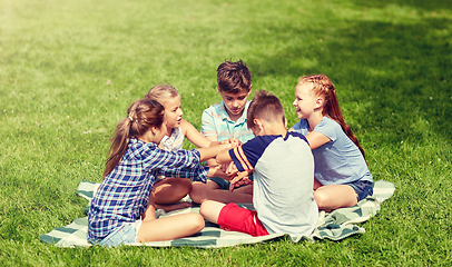 Image showing group of happy kids putting hands together