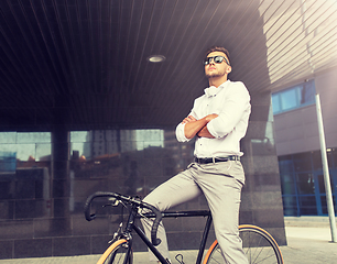 Image showing man with bicycle and headphones on city street