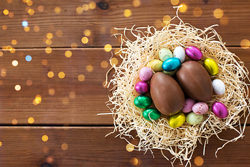 Image showing chocolate eggs and candies in straw nest