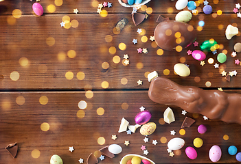 Image showing chocolate eggs, easter bunny and candies on wood