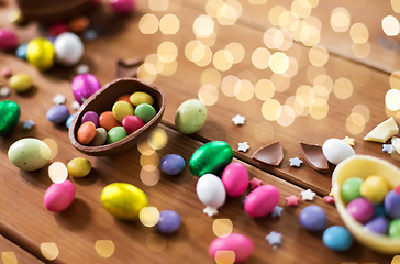 Image showing chocolate eggs and candy drops on wooden table