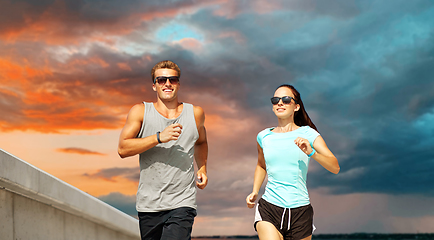 Image showing couple in sports clothes running outdoors