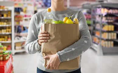 Image showing close up of woman with paper bag full of food