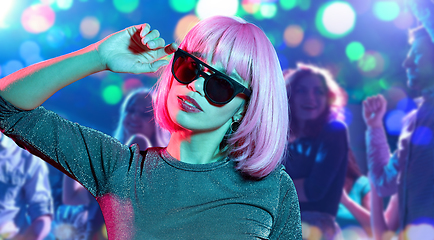 Image showing woman in pink wig and sunglasses at nightclub