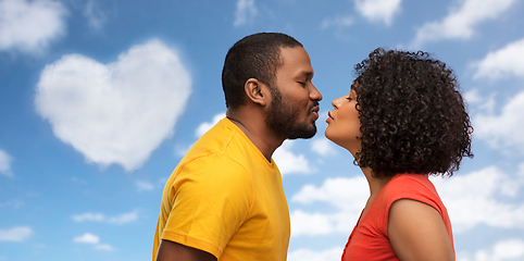 Image showing happy african american couple reaching for kiss