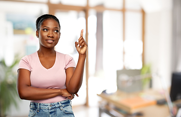 Image showing happy african american woman pointing finger up