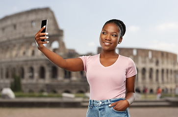 Image showing african american woman taking selfie over coliseum