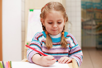Image showing Cute little girl painting