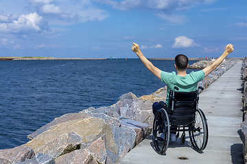 Image showing Disabled man in a wheelchair at the sea