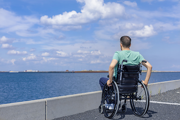 Image showing Disabled man in a wheelchair at the sea