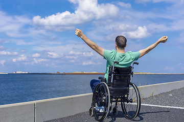 Image showing Disabled man in a wheelchair at the sea