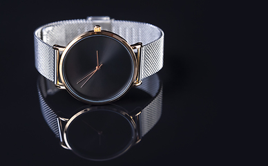 Image showing Wrist watch with metal strap for women on black background