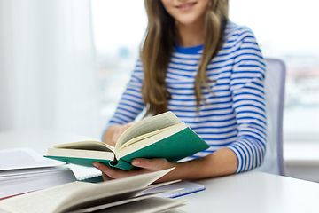 Image showing close up of student girl reading books at home